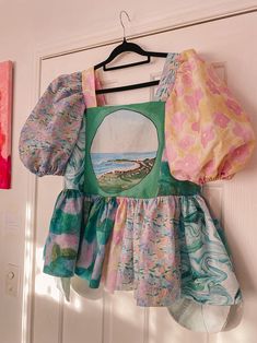 a child's dress hanging on a door hanger