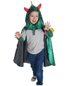 a little boy wearing a green costume with horns