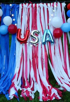 an american flag banner with the word usa on it and red, white, and blue streamers