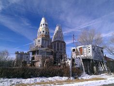 an old building with many windows and balconies on the roof is covered in snow