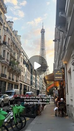 the eiffel tower in paris is seen from an alleyway with parked bicycles