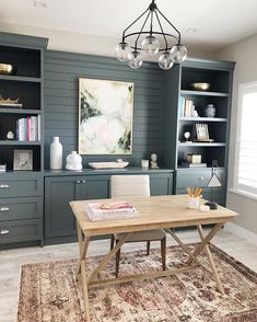 an office with built in bookshelves and desk