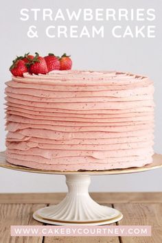 a strawberry cake with pink frosting and strawberries on top