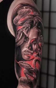 a woman with a snake tattoo on her arm and shoulder, in black and red