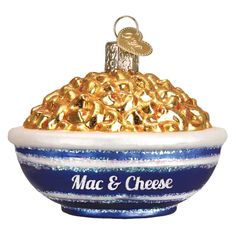 a blue and white bowl with gold rings on the rim that says mac & cheese