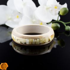 "Avant-garde style amber wood bangle bracelet. Beholds perfectly crafted, smooth, shiny and glossy rare marble, white and butterscotch Baltic amber set in birch wood. Earthy remains preserved in resin will make a real talking point for the wearer. Handcrafted to a standard of perfection will make a meaningful gift or just another wonderful love token for yourself or your special someone. *Rare Marble Baltic Amber 40 - 90 million years fossilized tree resin *Inner Diameter: EU - 7 cm / US - 2.7\" Adjustable Bone-colored Bracelet, Wood Bracelet, Love Token, Amber Beads, Avant Garde Fashion, Bracelet Bangle, Baltic Amber, Birch Wood, Large White