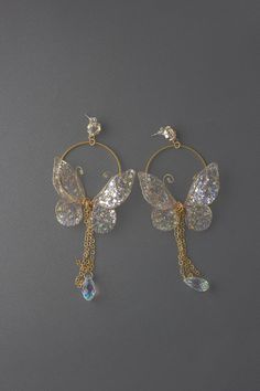 "Butterfly Gold Hoop Earrings UV resin Dangle Earrings These earrings can be a great addition to both a wedding dress and casual wear, relatively small size and perfectly combined with a dress and a suit    ♥ Love it and want to buy later? Click on the heart to your right that says \"Favorite.\" ♥ Want it now? Click the green \"Add to cart\" button. ♥ Want it now fast? Check our UPS delivery terms. https://www.etsy.com/listing/720565399/flower-fairy-express-delivery-with-ups-3 ♥ View more earrings; https://www.etsy.com/shop/FairyFlowerJewelry?section_id=28072613 ♥ Questions about how to buy? http://www.etsy.com/help_guide_checkout.php ♥ Special request, customer order, or you just have a question for me? https://www.etsy.com/messages/new?with_id=141499540&referring_id=17183496&referring_ty Diamond Earrings Aesthetic, Inexpensive Jewelry, Magical Jewelry, Fancy Jewellery, Fancy Jewelry, Fashion Jewelry Earrings, Fantasy Jewelry, Girly Jewelry, Etsy Earrings Dangle