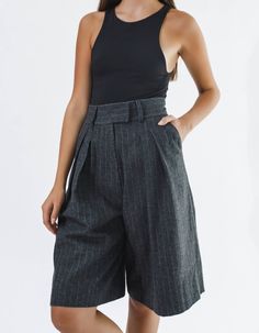 High-waisted knee-length shorts IPANTS.A wide waistband along with front pleats highlight the waist and make it visually thinner. Bermuda shorts are made from 100% striped wool in dark grey color and have an extra lining to be more pleasant to the body. Shorts have comfortable side pockets and faux pockets on the back. Belt loops, zip, and hook-and-eye closures on the middle.Composition: 100% woolLining: 100% viscoseCare: We recommend a professional dry clean. Do not wash. Do not bleach. Do not Below Knee Shorts Outfit, Bermuda Shorts Outfit Street Styles, Grey Shorts Outfit, Bermuda Shorts Outfit, Body Shorts, Gray Palette, Trouser Shorts, Suit Shorts, Smart Shorts