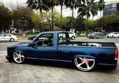 a blue pick up truck parked on the street