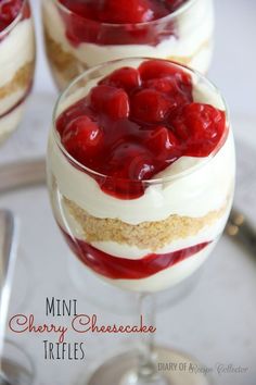 mini cherry cheesecake trifles in small glasses on a white table with silverware