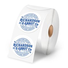 two rolls of white stickers on top of each other with blue and white logos