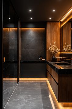 a black and gold bathroom with marble counter tops