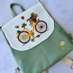 The Personalized Handmade Bag Bicycle Embroidered Backpack🚲 is a stylish and versatile accessory perfect for women on the go. 🤩 This fabric backpack is carefully crafted with love and attention to detail, making it a unique and special gift for her.😍 😘  The exquisite bicycle embroidery🚲 adds a charming touch to the bag and showcases the artistry and craftsmanship that went into its creation. 🚲Versatile Design:  This bag offers the convenience of both a backpack and a shoulder bag, allowing you to switch between styles effortlessly.🤩 It also offers a carry-on option, making it ideal for travel or everyday use.🎒 Product features ; Outer Fabric: Water repellent and stain resistant fabric. Inner Fabric: 100% cotton fabric. There are 2 pockets on the outside and 1 pocket on the inside. Bicycle Embroidery, Autumn Bag, Fabric Backpack, Embroidered Backpack, Special Gifts For Her, Multipurpose Bag, Embroidered Bag, Handmade Bag, Stain Resistant Fabric