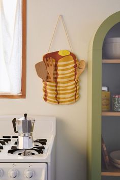 a stove top oven sitting next to a wall mounted pot holder