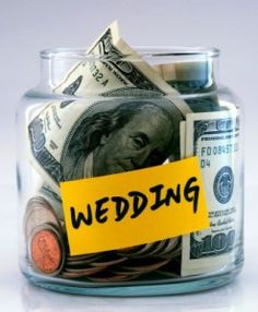 a glass jar with money in it and a yellow sign that says wedding on it