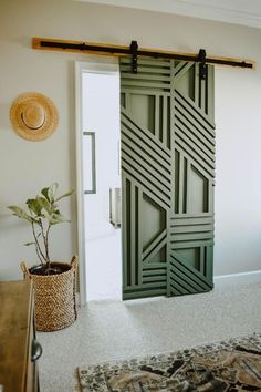 an open door in a living room next to a potted plant