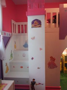 a child's bedroom decorated in pink and white with princess wall decals on the walls