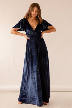 Lulus Exclusive! Make your debut in the Lulus Absolutely Amazed Navy Blue Velvet Flutter Sleeve Maxi Dress and watch the jaws drop! This gorgeous stretch velvet maxi stuns with its surplice bodice, short flutter sleeves, and high empire waist. A-line maxi skirt cascades below for a glam finish. Hidden back/zipper. Fit: This garment fits true to size. Length: Floor length. Size small measures 60.5" from shoulder to hem. Bust: Great for any cup size. Waist: Fitted - very fitted at natural waist. H Velvet Navy Bridesmaid Dress, Navy Blue Velvet Dress Long, Navy Blue Velvet Bridesmaids, Navy Blue Velvet Dress Long Sleeve, Blue Velvet Maxi Dress, Navy Blue Velvet Dress, Flattering Bridesmaid Dresses, Navy Blue Maxi Dress, Winter Wedding Guest Dress