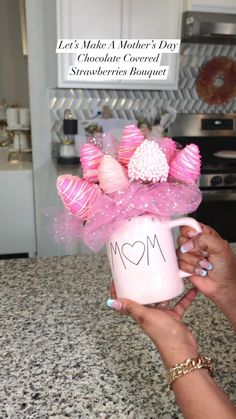 a woman holding a coffee mug with pink bows on it and the words let's make a mother's day chocolate covered strawberries bouquet