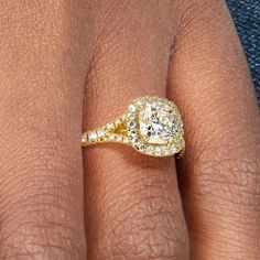 a woman's hand with a yellow diamond ring on her finger and an engagement band