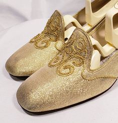 1960's gold lame' shoes with embroidered vamp and chunky heel Cute mid century modern pair of low heels. Size marked 7 B Measuresments: length ~ 9 1/2 inches, inside width ~ 2 3/4 inches, outside heel ~ 2 inches Sole reads: QualiCraft Worn 1x. These shoes are a ready to be worn! Buyer to pay all related shipping costs including insurance. Questions welcome. All Sales final Thank You CityVintage Holiday Gold Embellished Heels, Gold Slip-on Heels For Formal Occasions, Retro Almond Toe Wedding Heels, Retro Round Toe Heels For Wedding, Embellished Slip-on Party Wedding Shoes, Gold Slip-on Heels For Wedding, Gold Round Toe Wedding Shoes For Party, Gold Wedding Shoes With Round Toe For Party, Gold Slip-on Heels For Evening