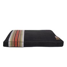 a black dog bed with multicolored stripes on the front and bottom, sitting on a white background