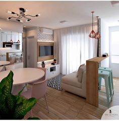 a living room filled with furniture next to a kitchen and dining room table in front of a window