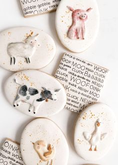 several decorated cookies with animals on them sitting on top of a table next to each other