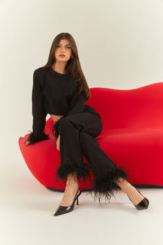 A woman setting in a black set with ostrich feathers on the sleeves and pants. Ostrich Feather Trim, Feather Trim, Ostrich Feather, Ostrich Feathers, Stepping Out, Staying In, Everyday Wardrobe, Elegant Woman, Matching Sets