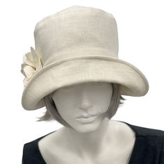 Handmade in the USAA hat isn't just about fashion, though the bespoke hats found here at Boston Millinery are the height of vintage style, it's about how you feel.It's about finding that finishing touch that make the corners of your lips uptick into a smile that shares your confidence and creativity.Wear this lovely Eleanor cloche hat to a garden party, the horse races, or an afternoon wedding and you’ll appear just as chic as Mary on Downton Abbey in today’s 20s. Meticulously crafted with care, Classic Brimmed Top Hat For Spring, Chic Adjustable Costume Hats With Short Brim, Fitted Cream Fedora For Spring, Fitted Beige Cloche Hat, Elegant Brimmed Fedora One Size Fits Most, Fitted Cream Panama Hat With Short Brim, Beige Cloche Hat For Church, Fitted Cream Hat For Vintage Events, Fitted Beige Cloche Hat For Church