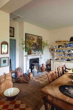 a dining room table with chairs and a fire place