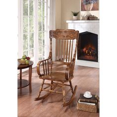 a wooden rocking chair sitting in front of a fire place next to a coffee table