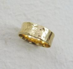 a gold wedding ring on a white background