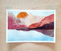 a piece of paper that has been altered to look like mountains and the sun is setting