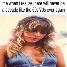 a woman with blonde hair and blue overalls standing in front of a white background