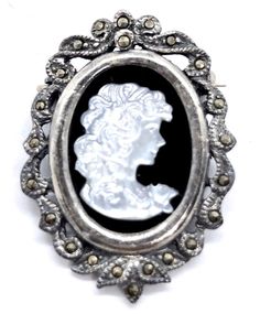 This is a very pretty pin. A sweet long haired girl is set on A Jet stone framed in a beautiful bow of marcasite. It is made with sterling silver and marked 925 TH on the back. An antique piece in great condition. Measures 2 in. Dates to pre - 1930. Jet Stone, Zodiac Pendant Necklace, Sterling Silver Marcasite, Zodiac Pendant, Cameo Brooch, Pin Pendant, Vintage Brooches, Vintage Signs, Earings Piercings