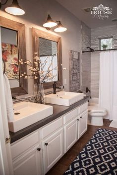 a bathroom with double sinks and two mirrors