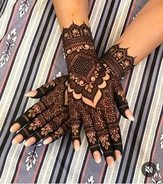 a woman's hands with hennap on top of her arm and hand