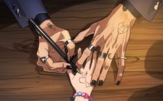 two hands holding each other while one holds the other's hand with an ink pen