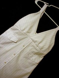 an apron is hanging on a hanger next to a black background with white pinstripe