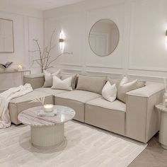 a living room filled with lots of white furniture