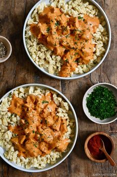 two bowls filled with rice covered in sauce