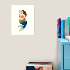 a painting of a mermaid sitting on top of a dresser next to a book shelf