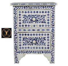 a blue and white cabinet with an ornate design on the front, two drawers below