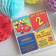 a birthday party with colorful paper decorations and tissue pom poms