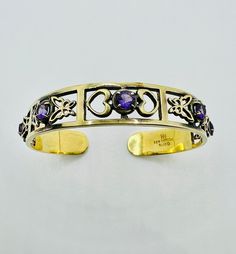 Experience the timeless charm of our 925 silver gold-plated vintage bangle, artfully decorated with precious amethyst gemstones. This exquisite piece of jewelry impresses with its detailed design, which harmoniously integrates butterfly and heart patterns. The gold-plated finish gives the bangle a luxurious shine, while the deep purple amethysts provide an elegant pop of color. Ideal for jewelry lovers and collectors, this bangle is both a stylish accessory for special occasions and a valuable g Butterfly And Heart, Vintage Bangles, Amethyst Bracelet, Bracelet Vintage, Amethyst Gemstone, Heart Patterns, Jewelry Lover, Purple Amethyst, Stylish Accessories