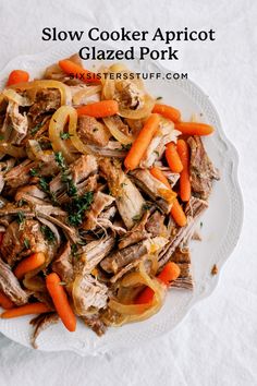 slow cooker apricot glazed pork with carrots and onions on a white plate