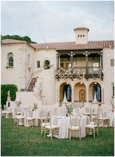 an outdoor venue with tables and chairs set up for a wedding reception in front of a large building