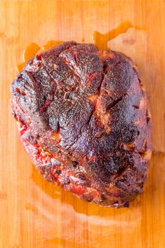 a piece of meat sitting on top of a wooden cutting board