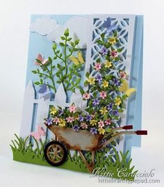 a handmade card with flowers in a wheelbarrow